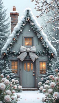 a house with a bow on the front door and snow covered trees in the background