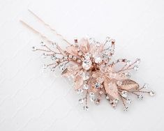 a bridal hair comb with crystal stones and leaves on the headpiece is shown against a white background