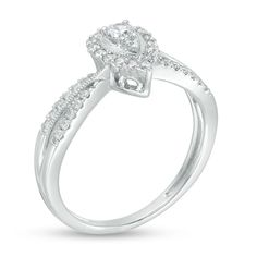 a white gold engagement ring with diamonds on the shoulders and an oval shaped center stone