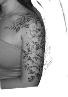 a woman's shoulder with flowers and leaves on her left arm, in black and white