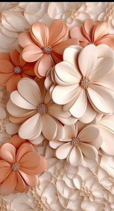 an arrangement of flowers made out of white and peach paper with diamond centers on the petals