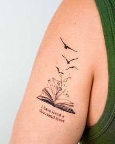 a woman with a book tattoo on her arm and the words i am not afraid to read