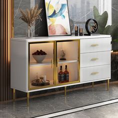 a white and gold sideboard with two open shelves next to a painting on the wall