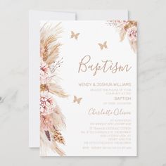 a white and gold wedding card with pink flowers on the front, butterflies in the background