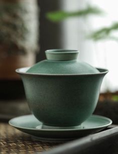 a tea cup and saucer sitting on top of a table