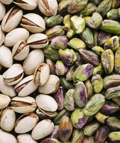 nuts and pistachios are shown in this close up photo, including the shell