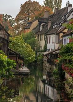 a river running through a small town surrounded by trees