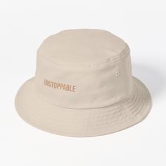 This packable, scrunchable, lightweight headwear classic is ready for adventure, from the beach to the street to the trail Breathable 100% cotton with eyelet ventilation Flat top Moderate brim is 2.2"" (5.5 cm) wide to keep the sun off your face Unstructured crown is 3.1"" (8 cm) deep Easy care: just spot clean and dry in shade. This "UNSTOPPABLE" bucket hat is for those who know no limits. Carry with you the unstoppable mindset in everything you do. Ideal for young individuals determined to ove Hats For Sale, Flats Top, The Trail, Bucket Hat, Carry On, Crown, Sun, Hats