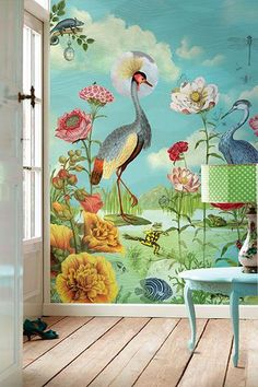 a room with flowers and birds painted on the wall