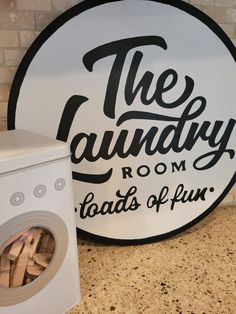 a laundry room sign next to a washing machine