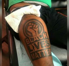 a man with a black lives matter tattoo on his arm