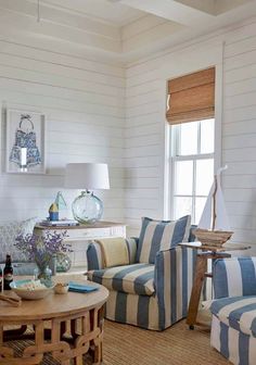 a living room with blue and white striped furniture