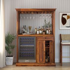 a wooden cabinet filled with bottles and glasses