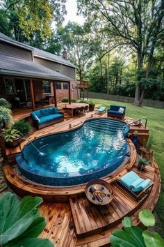 an above ground pool surrounded by wooden decking and furniture in the middle of a yard