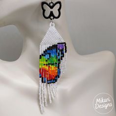 Hundreds of tiny Miyuki seed beads were woven together by hand to create these beautiful rainbow butterfly earrings. The earrings are light and comfortable to wear. These handmade beaded earrings make an excellent personalized gift for bridesmaids, Mothers Day, birthdays, Valentine’s Day, Wedding day, Christmas, New Year, and others. These earrings are made 100% by Hand. Approximate Length: 4.5 inches (includes stainless steel earring hook and butterfly charm) Beaded Butterfly Earrings, Butterfly Fringe, Handmade Beaded Earrings, Gift For Bridesmaids, Rainbow Butterfly, Handmade Earrings Beaded, Earring Hook, Butterfly Charm, Beautiful Rainbow