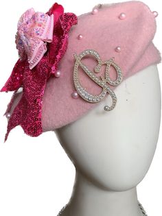 a white mannequin head with a pink hat on it's head and a bow