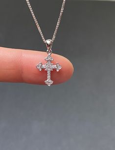 "Tiny Sterling Silver Cross CZ Necklace Minimalist and Dainty Metal: All components are made from solid .925 Sterling Silver Stone: Cubic Zirconia Measurement: pendant height is 21mm (0.83\") and 12mm (0.47\") wide Choose Chain Length At Checkout You can find other cross jewelry in my shop here https://www.etsy.com/shop/LinksAndStones?ref=seller-platform-mcnav&section_id=24376960 Please feel free to Convo me with any questions before purchasing. Please view policy before purchasing Thank You Diamond White Sterling Silver Cross Necklace For Gift, Gift Diamond White Sterling Silver Cross Necklace, Diamond White Sterling Silver Cross Necklace As Gift, Classic Cubic Zirconia Cross Necklace For Gift, Classic Cubic Zirconia Cross Necklace As Gift, Classic Diamond White Cross Necklace For Gifts, Tiny Cross Necklace, Necklace Combo, Sunshine Necklace