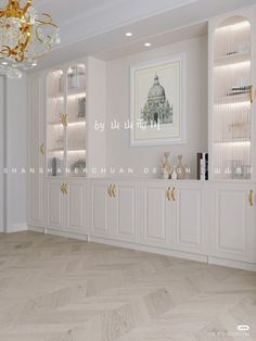 an empty room with white cabinets and gold accents