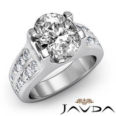 a white gold engagement ring with diamonds on the sides and an oval center stone in the middle