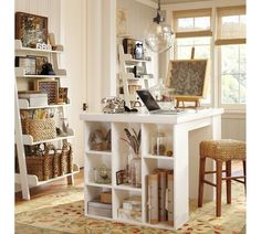 a white desk with shelves and chairs in front of a window, next to a chair