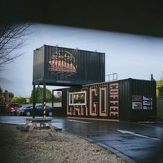 a couple of shipping containers sitting on top of a parking lot