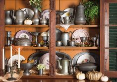 an old china cabinet filled with dishes and pots