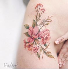 a close up of a woman's stomach with flowers on it