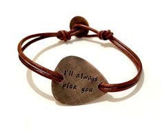 "Make the perfect personalized gift for the musician or music lover in your life. Hand stamped inspirational bracelet that carries messages, words, symbols, quotes and sayings to inspire, motivate and encourage the wearer. Metal - Copper Guitar Pick - The size and shape is of a standard guitar pick hand cut with my saw from 18ga metal sheet. Engraving - Hand stamped with up to 30 characters on each side. Leather - Double 2.2mm genuine leather with button clasp. Finish - Oxidized. Size - To find Music-themed Bracelet Jewelry Gift, Adjustable Bracelets For Father's Day Gift, Adjustable Bracelets As Father's Day Gift, Adjustable Hand-stamped Bracelet For Valentine's Day, Adjustable Hand Stamped Bracelet For Valentine's Day, Valentine's Day Adjustable Hand Stamped Bracelets, Adjustable Brown Jewelry For Personalized Gift, Valentine's Day Adjustable Hand-stamped Bracelet, Valentine's Day Adjustable Hand Stamped Bracelet