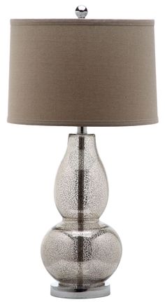 a table lamp with a beige shade on it and a light brown shade on the base