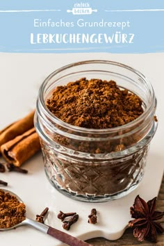 a glass jar filled with spices next to cinnamon sticks