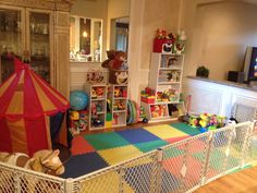 there is a play room with toys in it and a circus tent on the floor