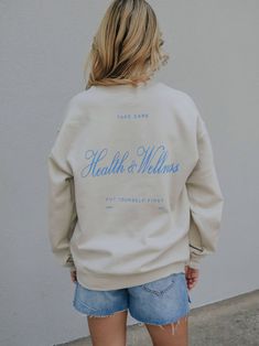 put yourself first and order this sweatshirt! you won't be able to resist the tan pullover with the pops of royal blue in your favorite cursive font! 50% Cotton, 50% Polyester School Merch, Sweatshirt Design Ideas, Mental Health Shirts, Healthy Girl Era, Wellness Branding, Aesthetic Hoodies, Put Yourself First, Wellness Club, Pretty Fonts