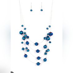 Featuring An Oil Spill Finish, Metallic Blue Beads And Faceted Crystal-Like Accents Are Fitted In Place Along Dainty Wires, Creating The Illusion Of Floating Layers Below The Collar. Dainty Silver Beads And White Rhinestone Encrusted Silver Rings Sporadically Embellish The Stellar Display For A Timeless Finish. Features An Adjustable Clasp Closure. Elegant Blue Beaded Necklaces For Party, Blue Necklaces With Colorful Beads For Party, Blue Beaded Chain Necklace For Party, Party Necklaces With Colorful Blue Beads, Blue Round Bead Necklaces For Parties, Blue Round Beads Necklaces For Party, Orange Necklace, Oil Spill, Pearl Necklace Earrings