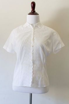 "Vintage White Short Sleeve Button Down Vintage Blouse by H. Gross Classic  Measurements: Measurements are taken on a flat surface across one side of item.  Length: 24\" Bottom Across: 13.5\" Chest: 19\" Sleeve Opening: 6.5\" Great vintage condition sold AS IS." Vintage White Collared Top, Vintage White Short Sleeve Blouse, Vintage Fitted White Camp Shirt, Vintage White Shirt, Vintage White Collared Blouse, Vintage White Shirt With Button Closure, Vintage Blouse, White Short, Blouse Vintage