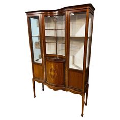 an antique display cabinet with glass doors