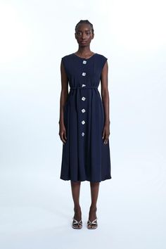 James Lakeland is revisiting classic lines marrying sophistication and comfort with this long crepe of jersey sleeveless dress. Featuring two practical front pockets, square mother-of-pearl buttons, and clever sashes sawn into the garment at the back to cinch the waist. Alternatively, wear it open as a chic long cardigan. Midi Dress Navy, Occasion Dresses Wedding, Petite Coat, Sleeveless Midi Dress, Navy Midi Dress, Petite Tops, Mother Of Pearl Buttons, Midi Dress Sleeveless, Pearl Buttons