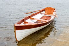 a small wooden boat floating in the water