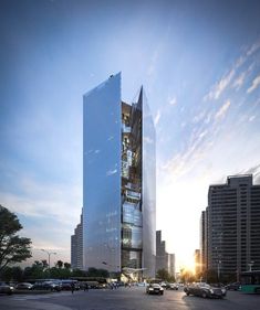 a very tall building sitting in the middle of a parking lot with cars parked around it