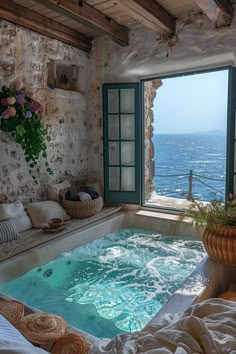 an indoor jacuzzi is shown in front of a large window overlooking the ocean