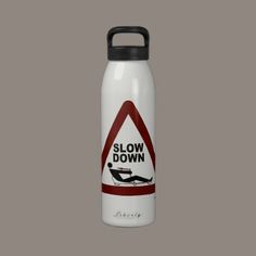 a white water bottle with the words slow down on it and a red triangle sign