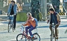 three people riding bikes and one is on a bike