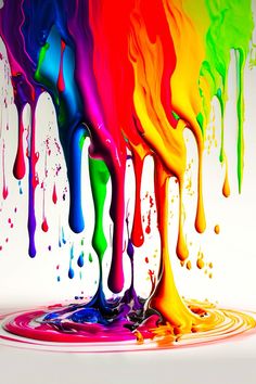 multicolored liquid flowing down the side of a white surface with drops of paint on it