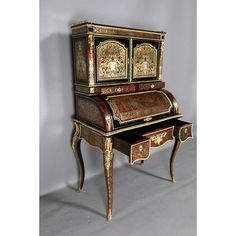 an antique writing desk with ornate designs on it