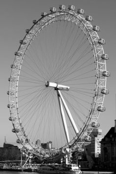 a large ferris wheel sitting on top of a river