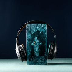 the headphones have been placed on top of this book with an image of jesus