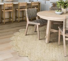 a round table with chairs around it in a kitchen