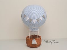 a blue and white hot air balloon in a basket