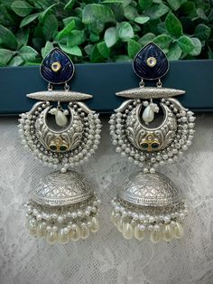 Black metal oxi jhumki earring. About 5.5 inch long and 2 inch wide. Light weight, pachi kundan work in emerald green. Pearl details. Luxury Kundan Jhumkas In Temple Jewelry Style, Luxury Silver Kundan Jhumkas, Luxury Heavy Jhumkas For Navratri, Cheap Heavy Chandbali Jhumkas, Metal Chandelier Earrings With Latkans In Temple Jewelry Style, Metal Chandbali Bridal Earrings, Metal Chandbali Chandelier Earrings With Latkans, Metal Chandbali Chandelier Earrings, Heavy Chandbali Chandelier Earrings In Metal