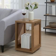 a living room with a couch, coffee table and bookshelf on the floor