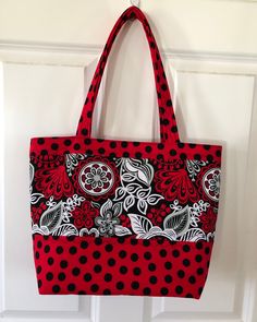 Beautiful red, white and black quilted tote style handbag Approx dimensions-14" w x 12" h x 5"d w/ 2 21 " handles Machine wash/ Line dry Perfect for all occasions 5 interior pockets w/ a magnetic closure 100% Cotton Red Quilted Shoulder Bag For Travel, Red Quilted Travel Shoulder Bag, Red Quilted Travel Bag, Reversible Red Shoulder Bag, Red Reversible Shopping Bag, Red Reversible Bag For Shopping, Red Reversible Shoulder Bag, Red Reversible Bag For Daily Use, Red Quilted Rectangular Shoulder Bag